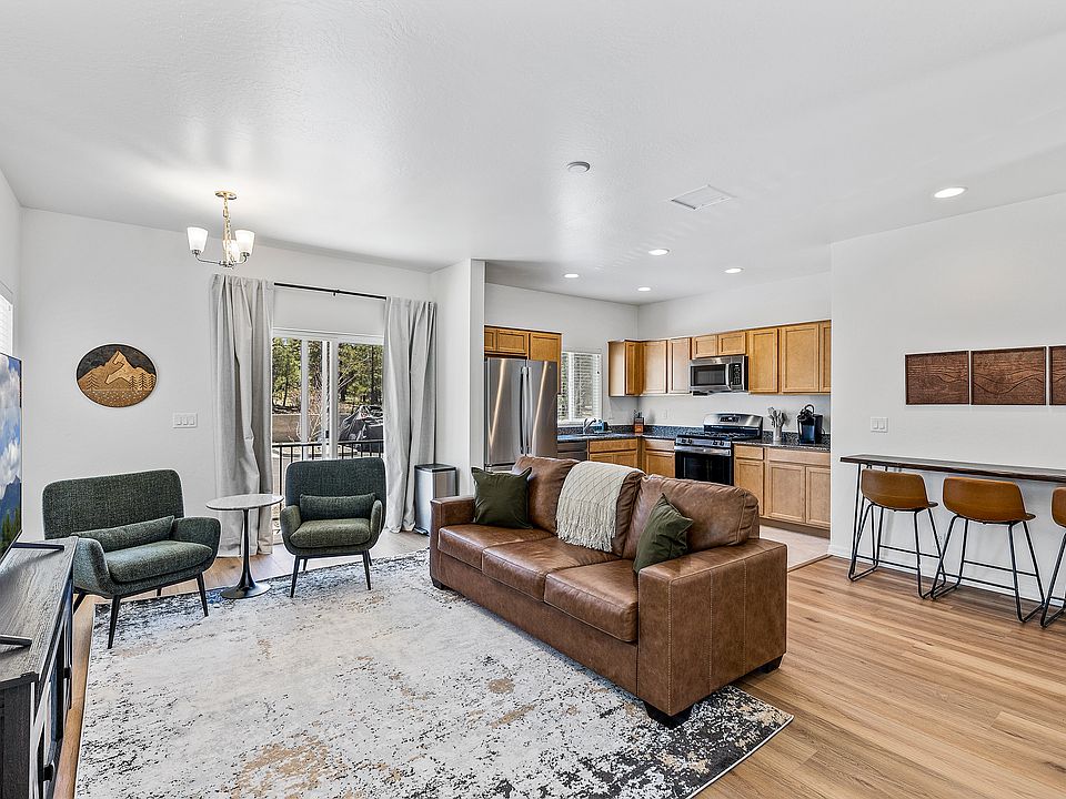 Fully furnished living room with forest views