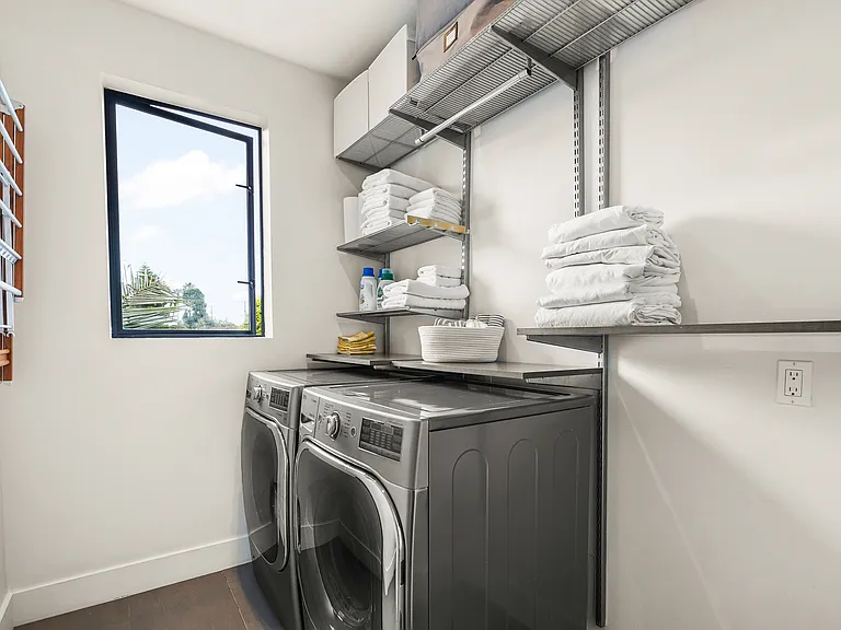Laundry room upstairs with storage