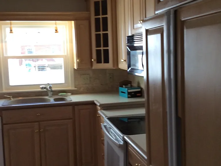 Updated kitchen and sunny kitchen with views of the backyard.