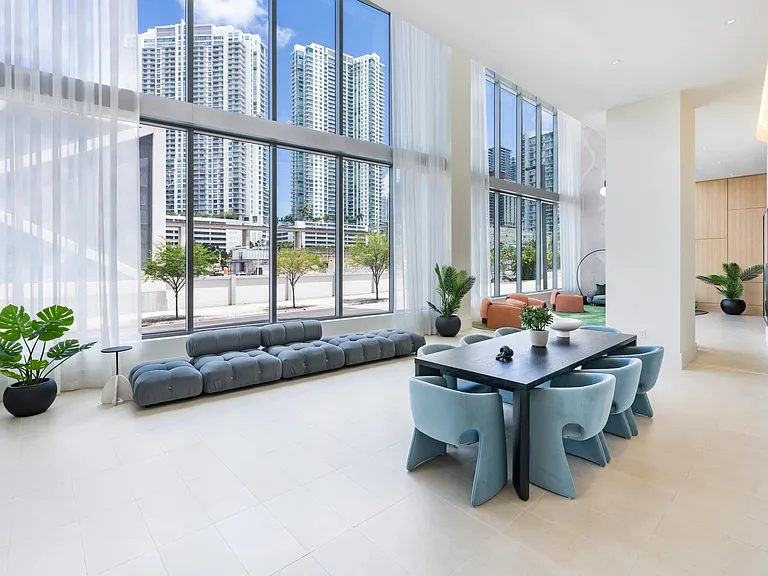 Expansive windows and chic seating make Modera Riverside's lobby lounge a welcoming retreat in downtown Miami.