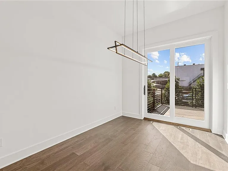 Dining Area (Unit Entrance (Note: Actual unit has light wooden floors and upgraded fixtures / appliances)