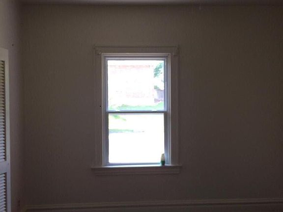 bedroom shows new window and ceiling fan, 2017
