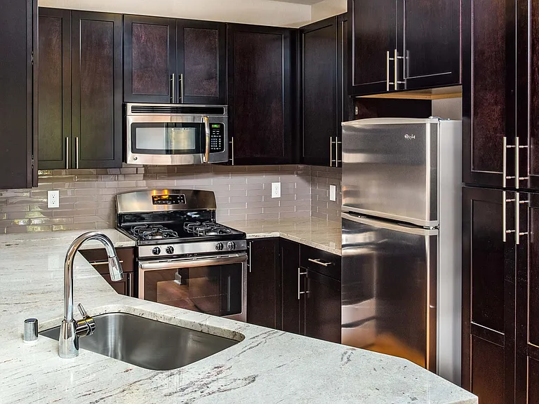 Modern kitchen with stainless steel appliances, granite countertops and premium cabinetry