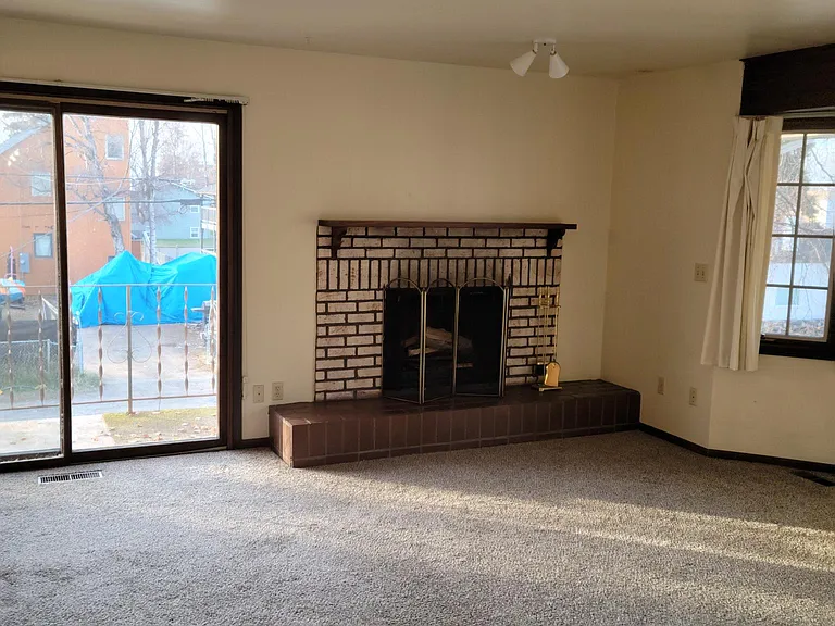 Livg room fireplace and sliding door to balcony