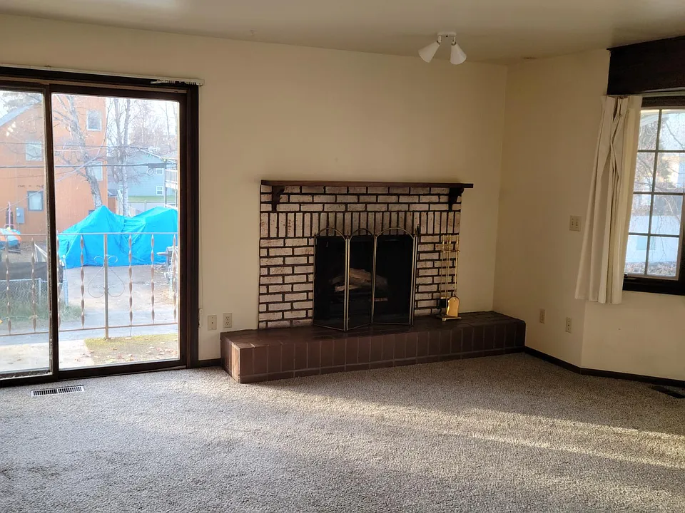 Livg room fireplace and sliding door to balcony