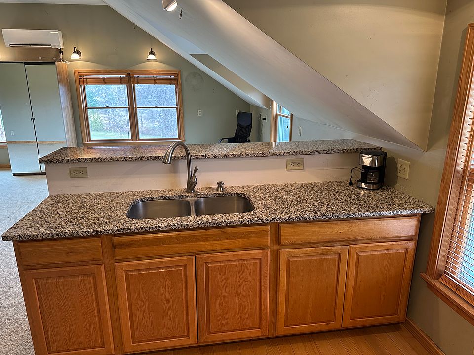 Granite counter and bar are 93" long. Twin stainless steel sinks. North windows on far wall.