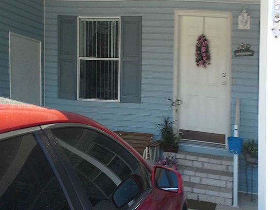 Under carport, facing front door