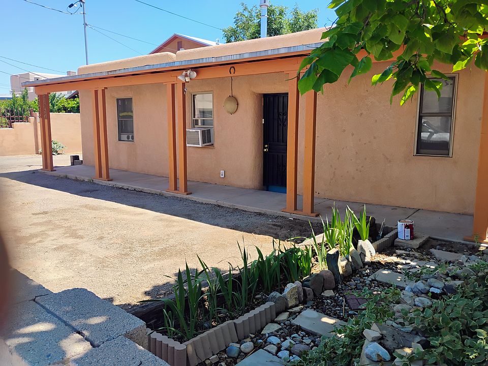 Front of house with covered porch and parking space.