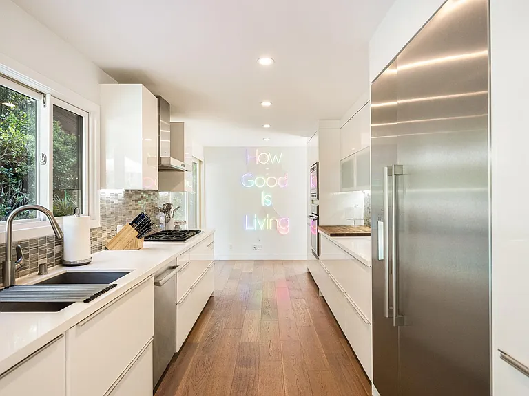 The sleek kitchen boasts top-of-the-line appliances and ample counter space.