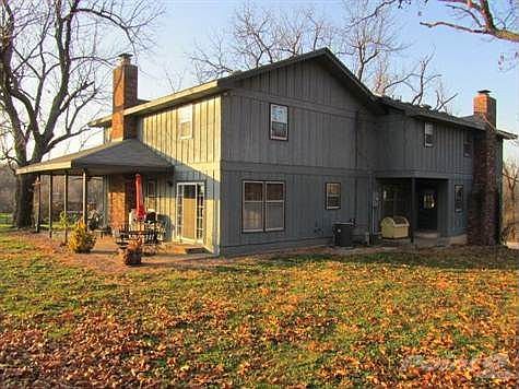 Back/side view of the home shows the large, covered patio area.