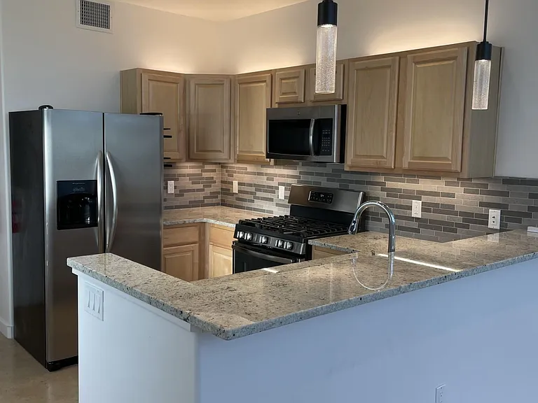 The kitchen in 3202 "The Edward" Loft comes with a breakfast-bar.