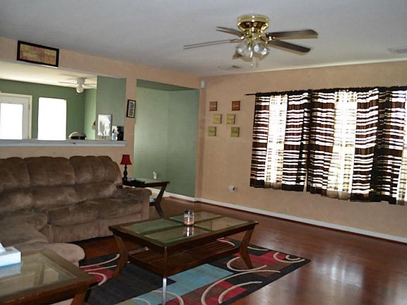 View of open living area with lots of windows from hallway.