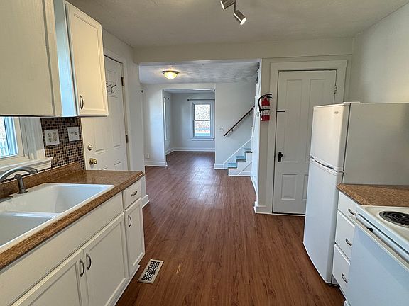Freshly painted and clean kitchen, with dining and living room beyond (looking toward front of house)