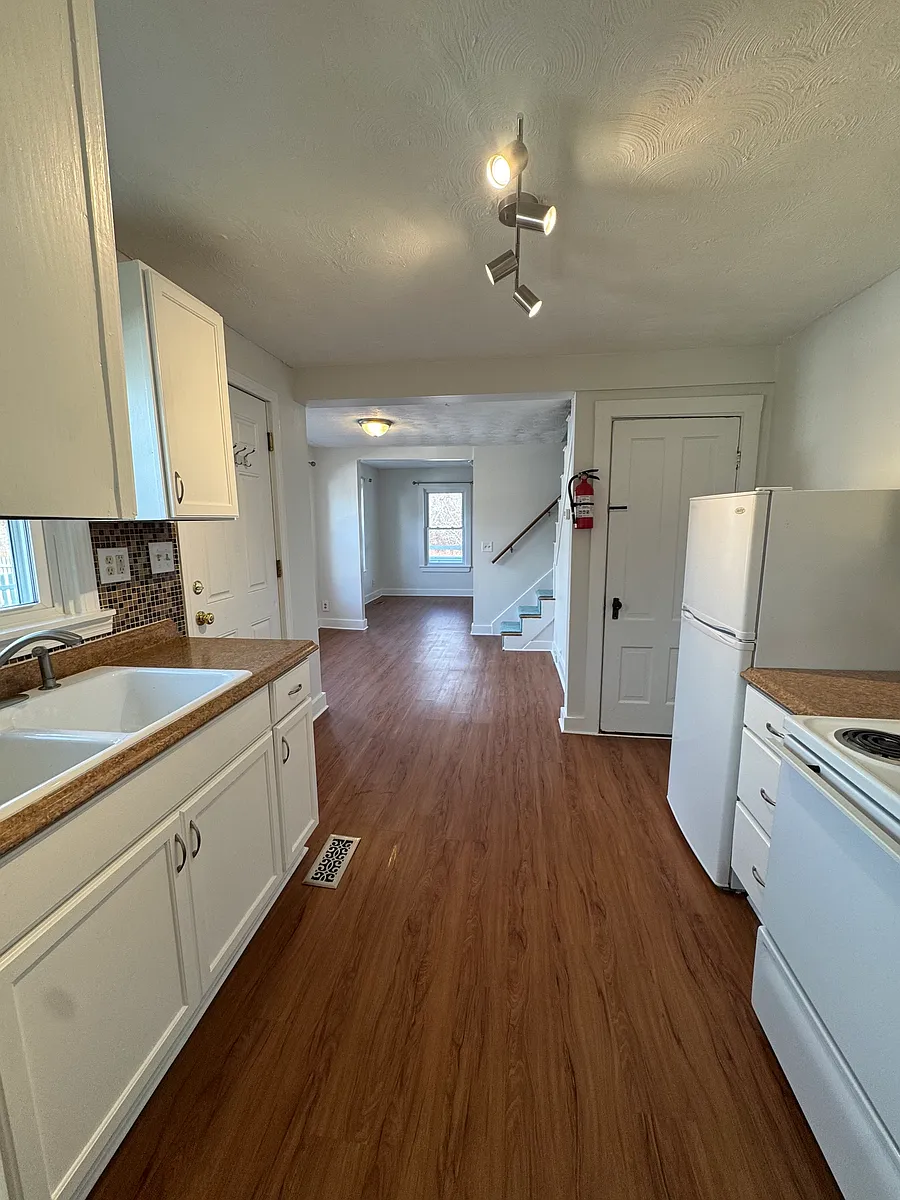 Freshly painted and clean kitchen, with dining and living room beyond (looking toward front of house) - 178 Carroll St