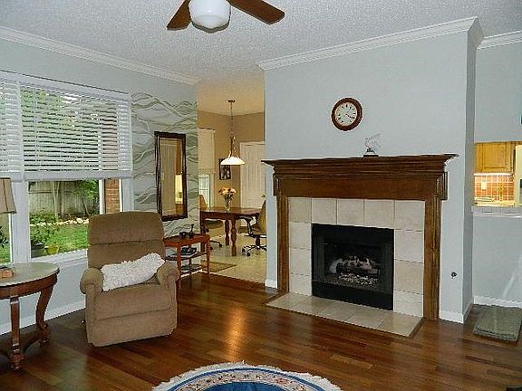 The family room has a gas fireplace and gorgeous hardwood floors.