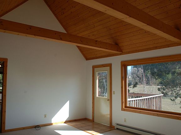 Bright sunny living room with cathedral ceilings.