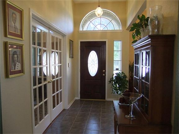 Entry features high ceilings and splits Study and Formal Dining Room