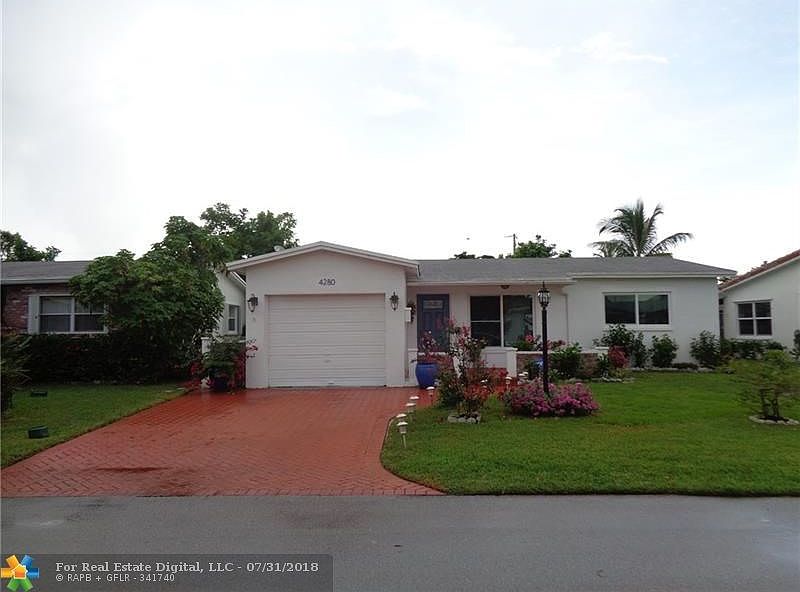 Front of house with paver driveway and lots of curb appeal.