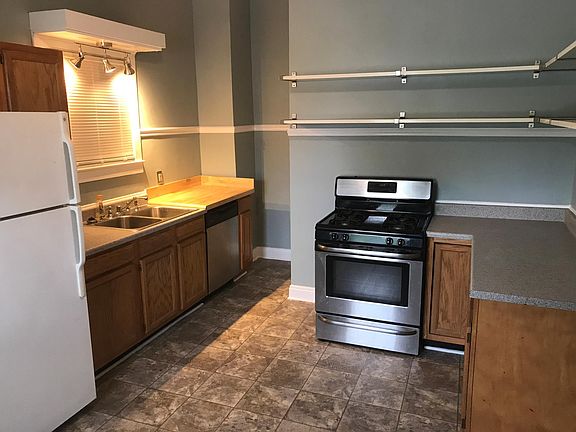 Eat in kitchen with gas stove and butcher block for cutting