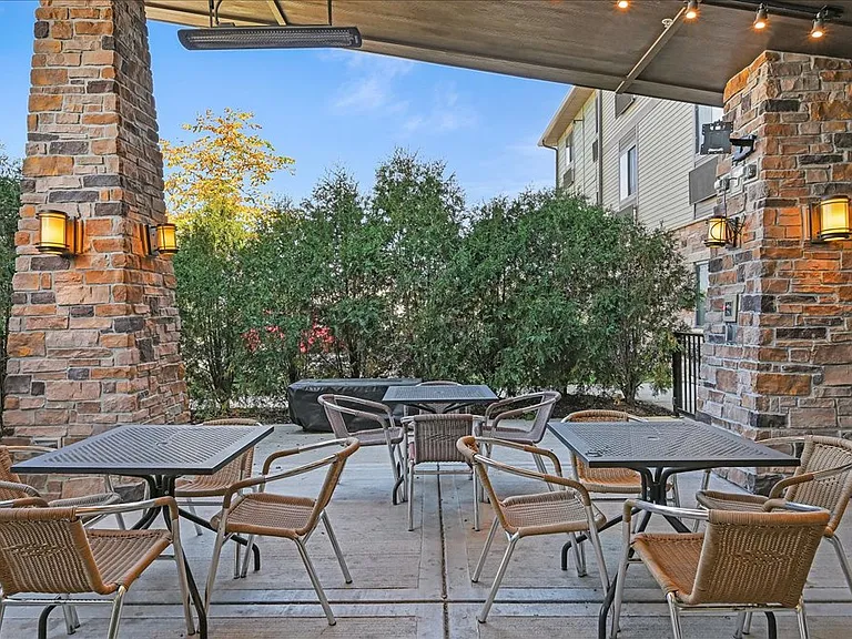 Outdoor patio with fire table and heat lamps for year round use.