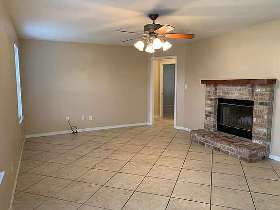 living room with wood burning fireplace