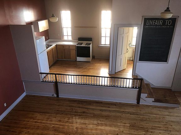 View from loft bedroom overlooking part of living room and the kitchen