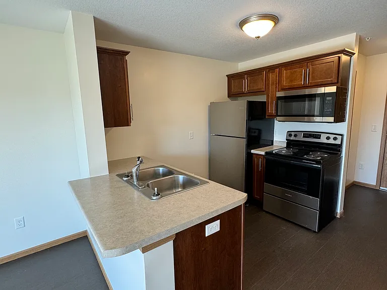 Kitchen, includes: Electric Stove/Oven, Refrigerator/Freezer, Dishwasher and Microwave.