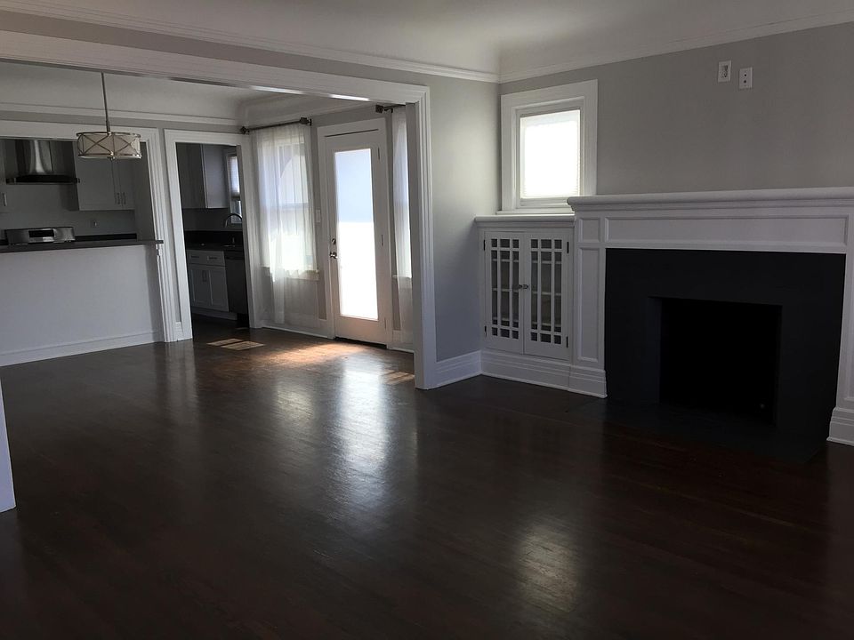 Living room with refinished hardwood floors and plenty of natural light.