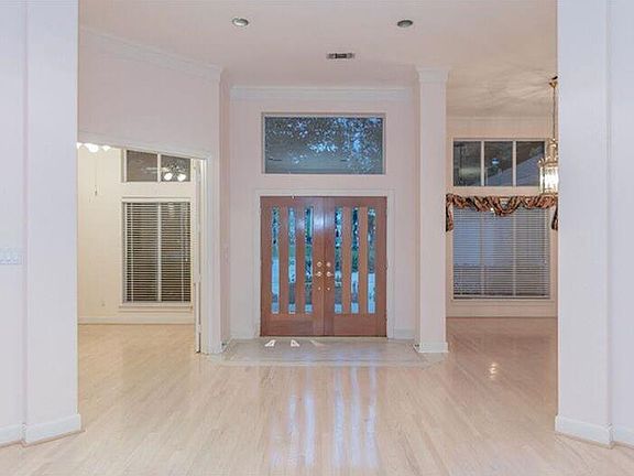 Beautiful door and generous windows allow lots of natural light. Study to the left of the front door and Formal Dining to the ri