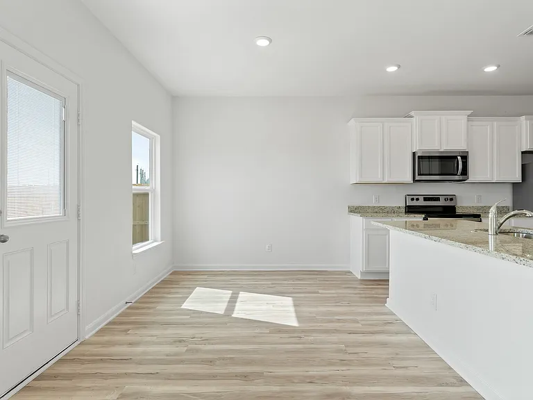 The dining room has a door that leads to the backyard.
