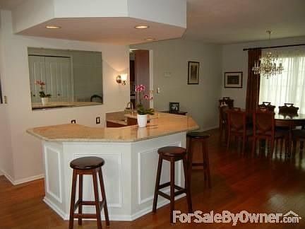 Bar and Formal Dining Room : Entertain guests at the wet bar with granite top and cherry cabinets.