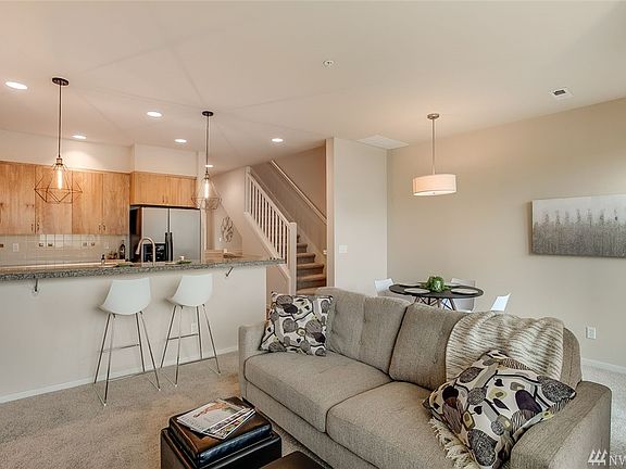 Kitchen with bar, gas stove, SS appliances that stay for your convenience.