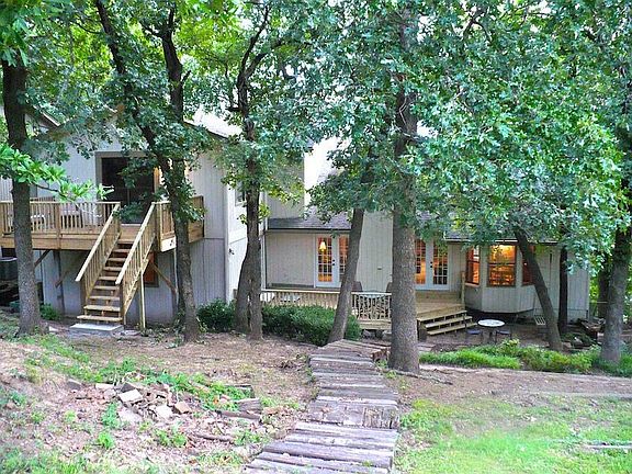 Wooded backyard with lots of shade trees.