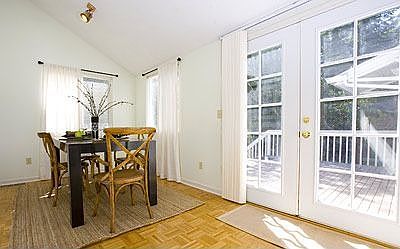 Large dining room with french doors that open to deck