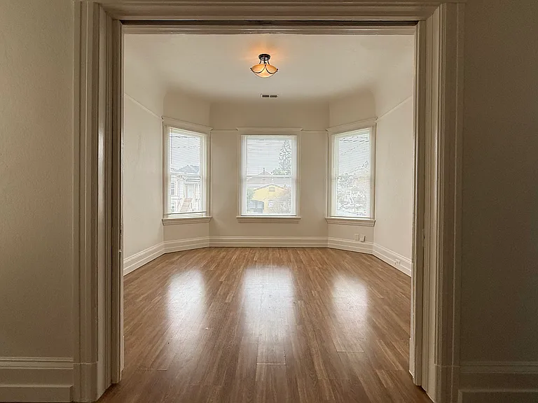 looking from inner living room through pocket doors to front living room