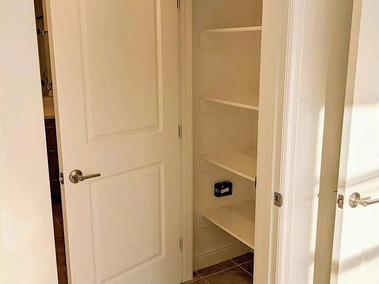 Linen closet in the en suite attached to master bedroom