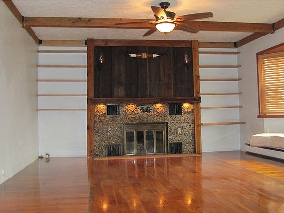 Custom design for this living room with Walnut mantle and solid Teak hardwood flooring. A one of a kind design not found anywhere else.