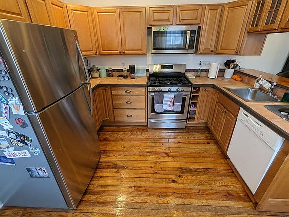 Kitchen with fridge, microwave, gas stove, and dishwasher