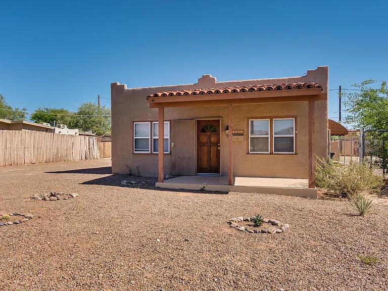 Large front yard with low maintenance and side yard for pet or garden.