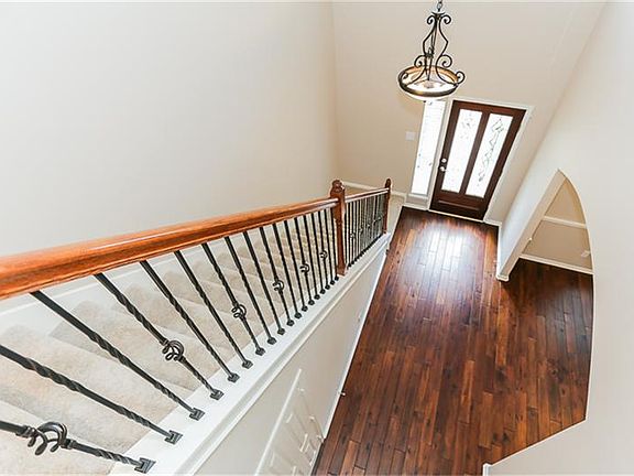 Wrought iron staircase in the 2 story entry.