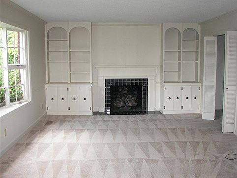 living room view with large window & built ins