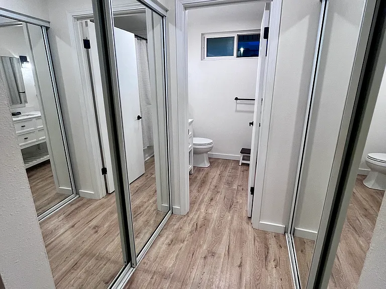 His and hers closet in master bedroom leading to master bathroom.