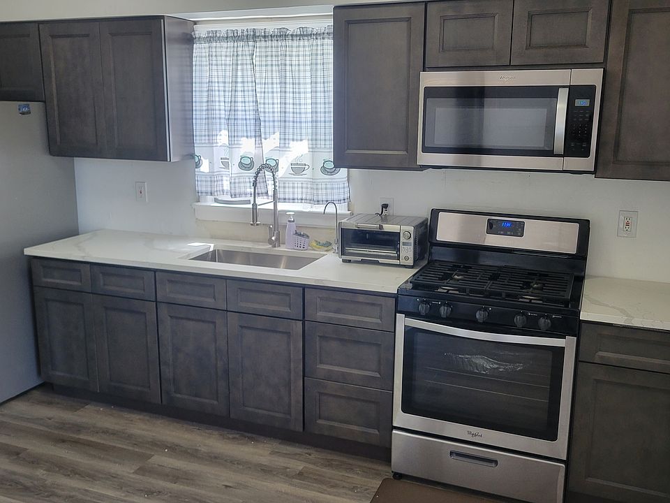 Renovated kitchen with quartz counter tops and breakfast bar