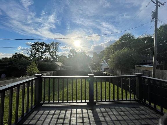 Back deck- view to back yard. Walk in basement door is down the steps.