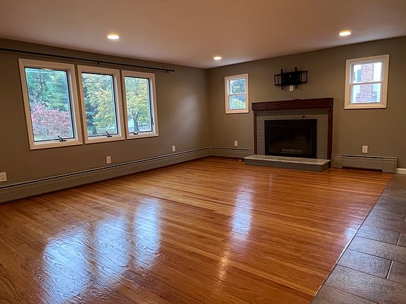 A TV mount with internet access is above the fireplace.