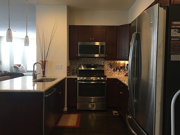 Kitchen includes stainless steel appliances, granite countertops and gas range. Counter height bar in kitchen has room to seat two.