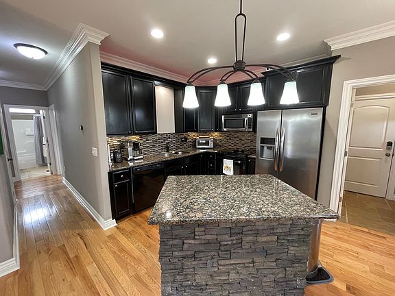 Kitchen refrigerator, built-in microwave, dishwasher, and garbage disposal all included.