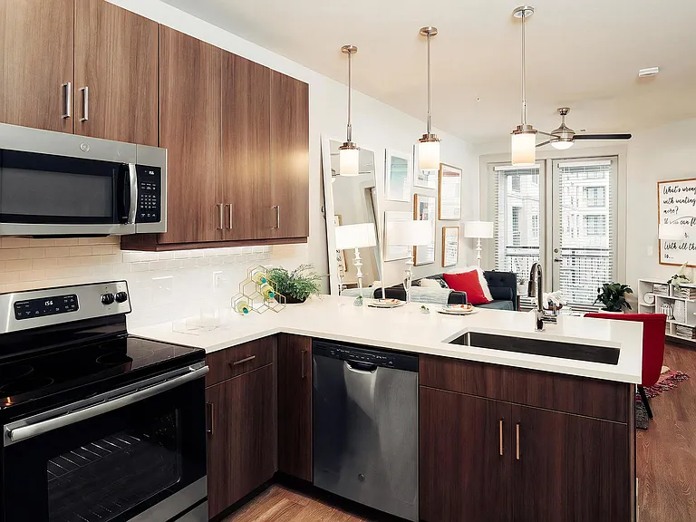 Open-Concept Layout with Kitchen, Living Area, and Access to Patio