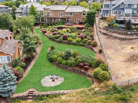 View of the back of the home and outdoor living space. Endless opportunities! 