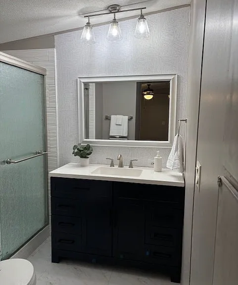 Master bathroom has a 4 foot vanity and large area for linen storage.